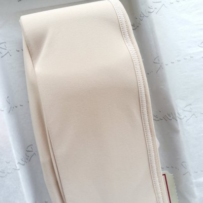 Faixa de tecido bege claro com costura visível sobre fundo branco