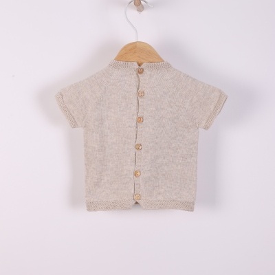 Camisa de malha bege claro com botões de madeira pendurada