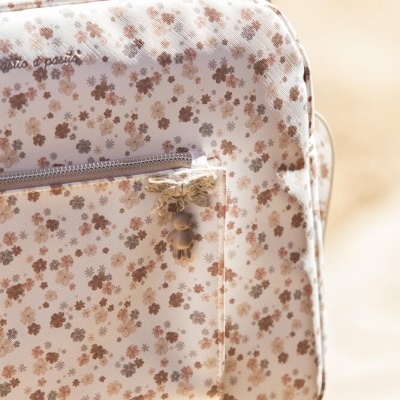 Mala bege com padrão floral castanho e bolso frontal com fecho e laço