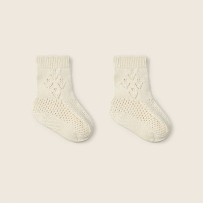 Par de meias creme tricotadas com padrão decorativo