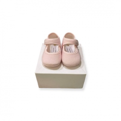 Sapatos de bebé rosa claro sobre caixa branca