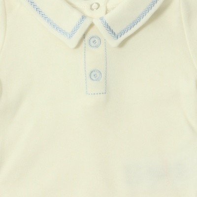 Peça de roupa infantil branca com gola bordada azul e dois botões azuis