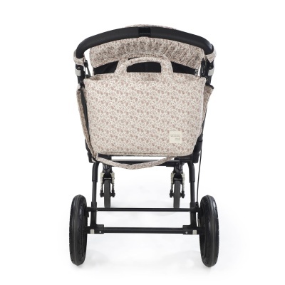 Carrinho de bebé com tecido estampado floral bege e castanho visto de trás