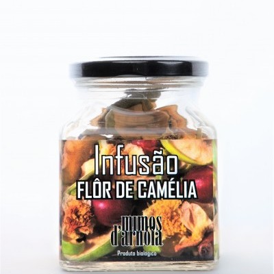 Frasco de vidro com infusão de flor de camélia e rótulo colorido