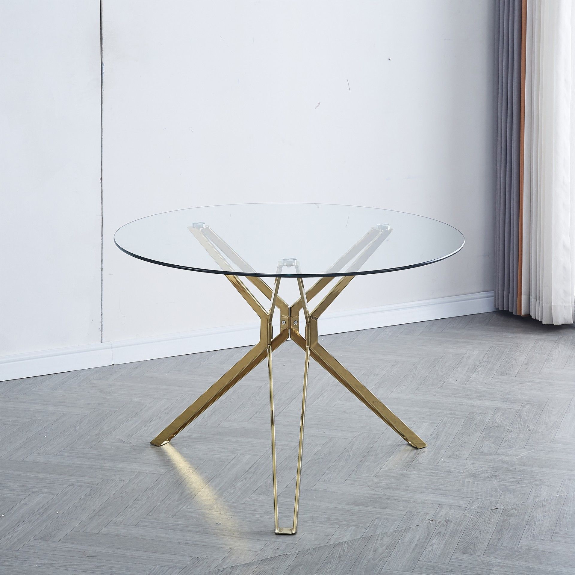 Mesa redonda de vidro com pés metálicos dourados