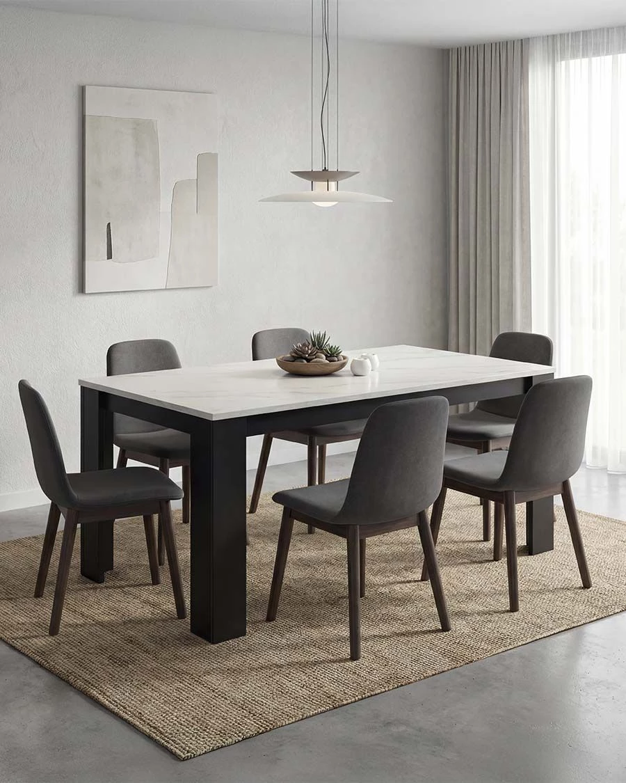 Sala de jantar com mesa branca, cadeiras cinzentas, tapete natural e lâmpada pendente