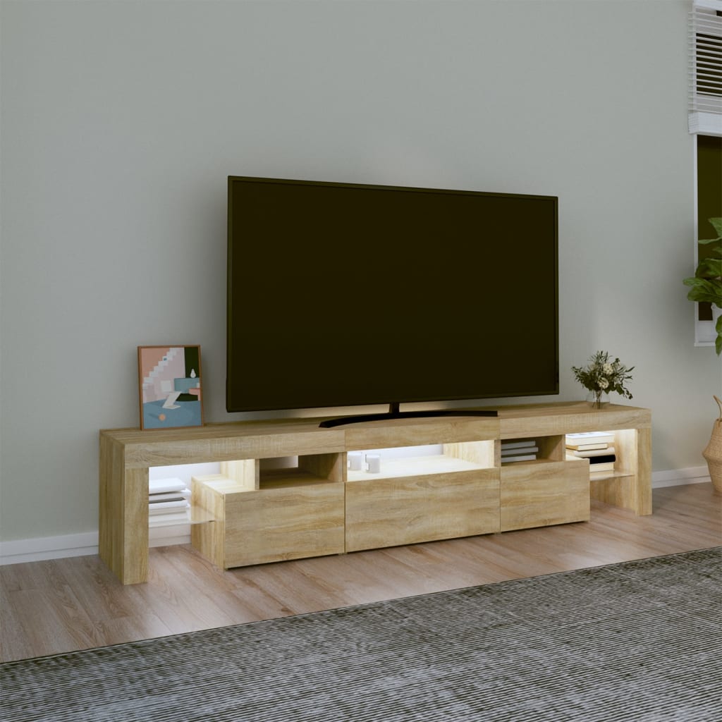 Móvel de televisão em madeira clara com gavetas e prateleiras iluminadas, televisão grande e decoração minimalista