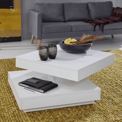 Mesa de centro branca com copos cinza, caderno preto e tigela decorativa em sala com sofá cinza
