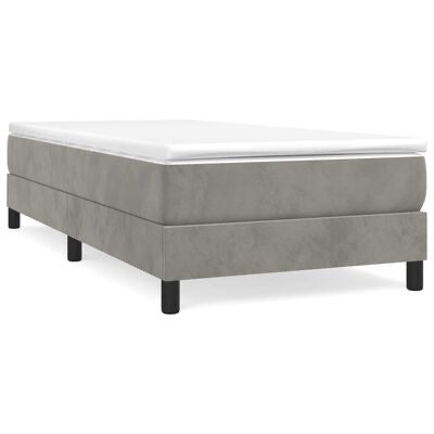 Cama individual cinza com colchão branco sobre fundo branco