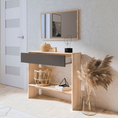 Consola em madeira clara com gaveta cinzenta, espelho de moldura de madeira, cesta, decoração preta e vaso com folhagem seca
