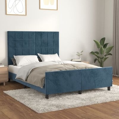 Cama de casal azul-escuro estofada com roupa de cama bege e branca numa sala clara com planta e quadros.
