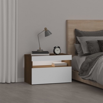Mesa de cabeceira cinzenta e branca ao lado de cama com roupa de cama cinzenta