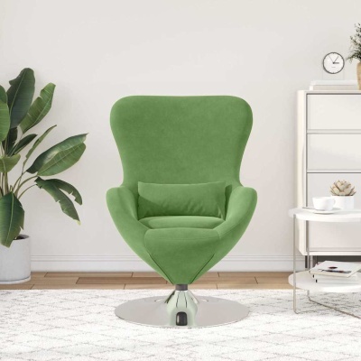 Cadeira verde moderna com base metálica numa sala minimalista com planta e mesa redonda branca.