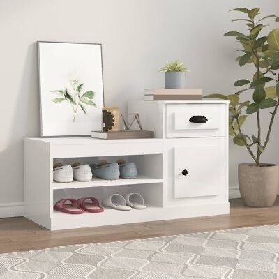 Móvel branco de madeira com gaveta, porta e prateleiras com sapatos, decorado com quadro, livros e planta