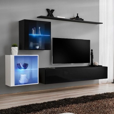 Móvel de parede moderno com iluminação LED azul, televisão e decoração numa sala de estar.