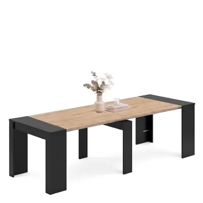 Mesa de jantar extensível com tampo de madeira e estrutura preta, decorada com vaso e cadernetas.