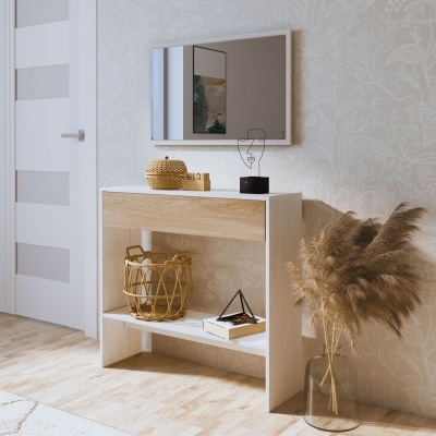 Consola branca decorada com objetos e vaso com plantas secas junto a parede com papel floral