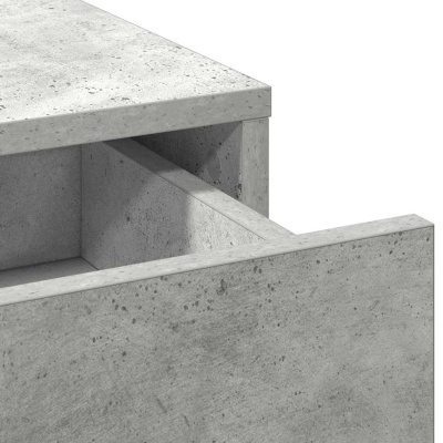 Cómoda cinza com textura de cimento e gaveta parcialmente aberta