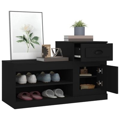 Móvel organizador preto com sapatos, gaveta, porta, livros, vaso com planta e quadros