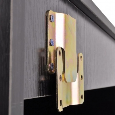 Chapa metálica dourada com parafusos fixada em superfície de madeira escura