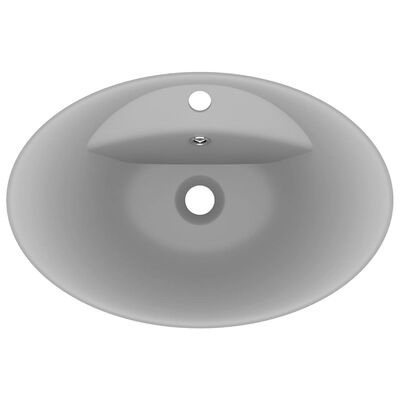 Lavatório oval branco em cerâmica com buracos para torneira e escoamento