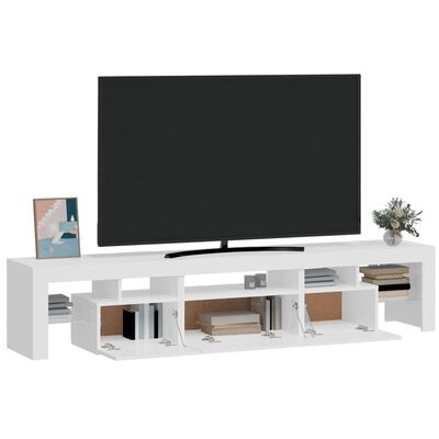 Móvel de TV branco com televisão preta, livros, moldura decorativa e vaso de flores