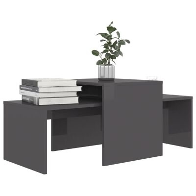 Mesa de centro modular cinza escuro com vaso de planta e livros.