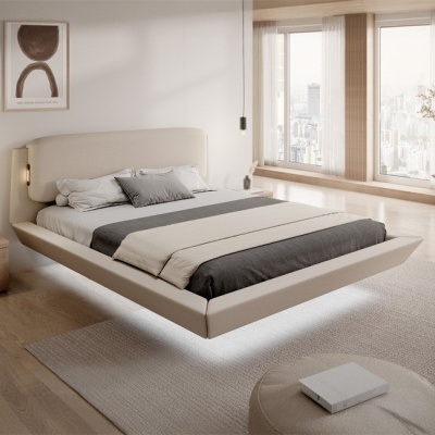 Quarto moderno com cama estofada bege e roupa de cama cinza e branca