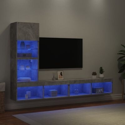 Móvel de sala de estar cinza com prateleiras iluminadas em azul e televisão na parede
