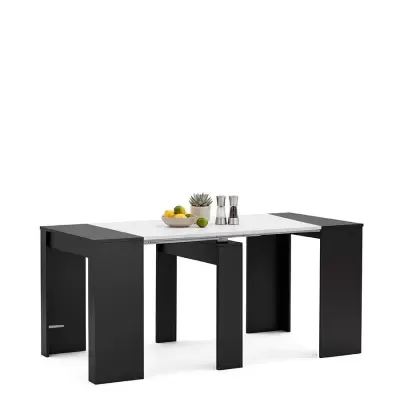 Mesa extensível branca e preta com decoração de frutas, planta e moedores
