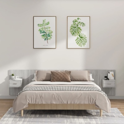 Quarto moderno com cama de madeira clara, almofadas castanhas, quadros de folhas verdes e mesas de cabeceira cinzentas.