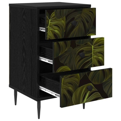 Móvel preto com três gavetas decoradas com folhas verdes, abertas, sobre pernas pretas