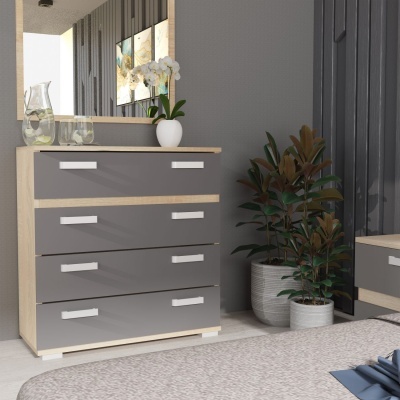 Cômoda cinza com quatro gavetas e puxadores brancos num quarto cinzento com plantas e decoração