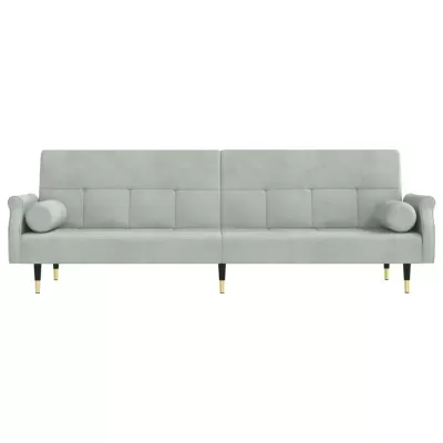 sofá cinza claro com almofadas cilíndricas e pernas pretas com detalhes dourados