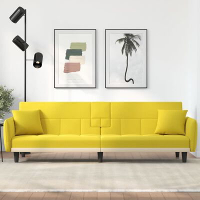 Sofá amarelo com duas almofadas em sala moderna com quadro e lâmpada de chão preta