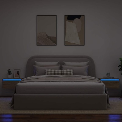 Quarto com cama cinzenta, mesas de cabeceira com luz azul e quadros abstratos na parede