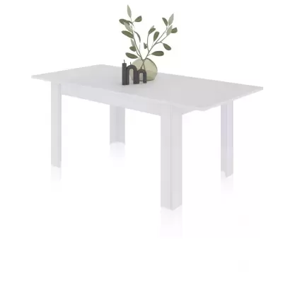 Mesa retangular branca com um vaso creme e velas pretas