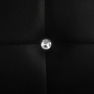 Superfície preta acolchoada com botão brilhante no centro