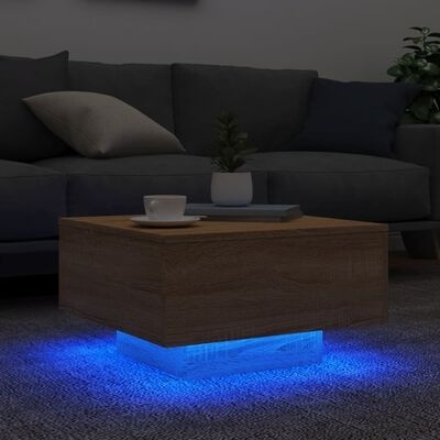 Mesa de centro em madeira com iluminação azul em sala moderna com sofá cinzento