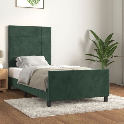 Cama individual estofada verde com cabeceira quadriculada, manta cinza e planta decorativa
