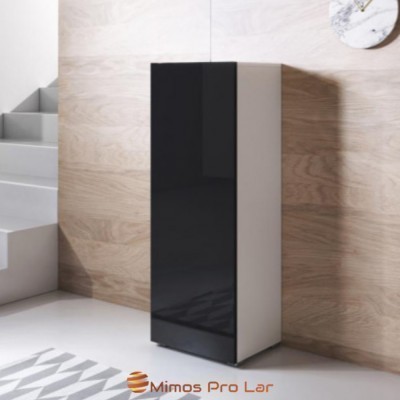 Móvel alto estreito com porta preta e corpo branco numa sala moderna com parede de madeira clara e escadas cinzentas