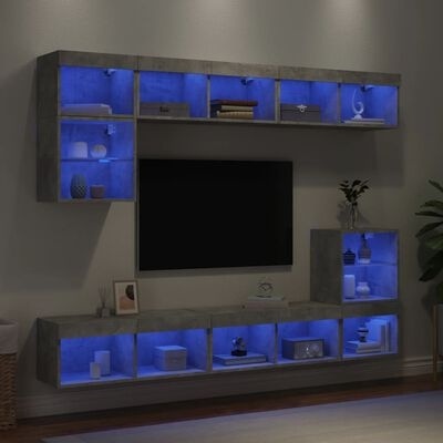 Móvel de parede com prateleiras em concreto e iluminação LED azul com objetos decorativos.