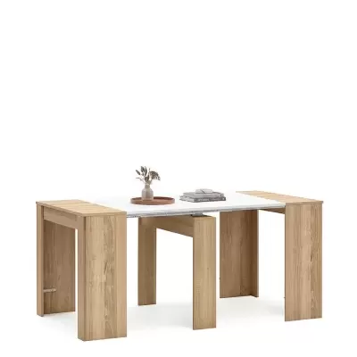 Mesa extensível de madeira clara com tampo branco e decoração simples.