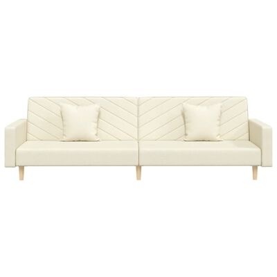 Sofá bege claro com padrão em espinha de peixe e duas almofadas.