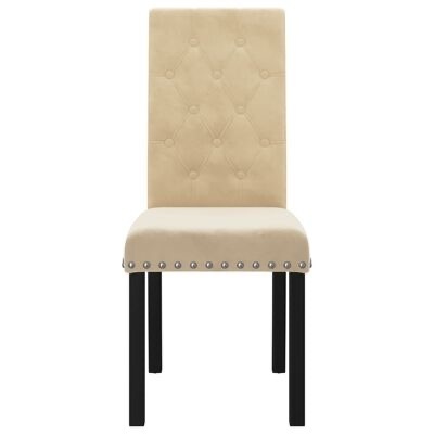 Cadeira estofada bege com pernas pretas e detalhes em tachas prateadas