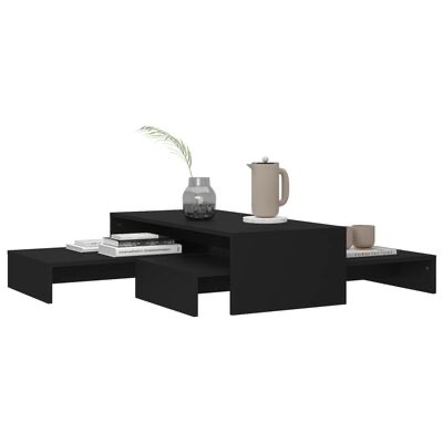 Mesa de centro preta modular com vaso, jarro, chávena e livros.