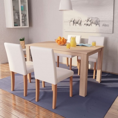 Conjunto de mesa de madeira clara com quatro cadeiras brancas, tapete azul, e quadro de elefantes na parede.