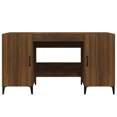 Secretária de madeira castanho escuro com duas portas e gaveta, puxadores e pernas pretas.