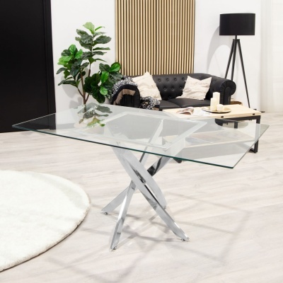 Mesa de vidro com base metal cromada em sala moderna e sofá escuro