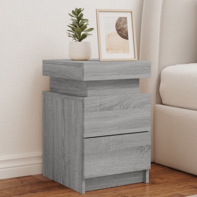 Mesa de cabeceira cinza com vaso de planta verde e quadro decorativo abstrato